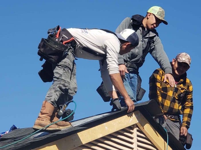 Amos Roofing crew performing a roof inspection
